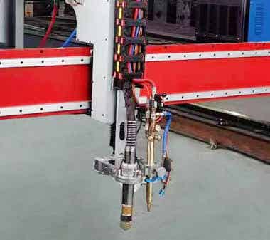 Close - up of flame cutting machine head with pipes and wires